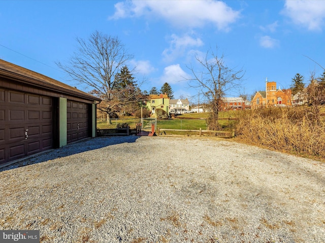 view of yard with a garage and an outdoor structure