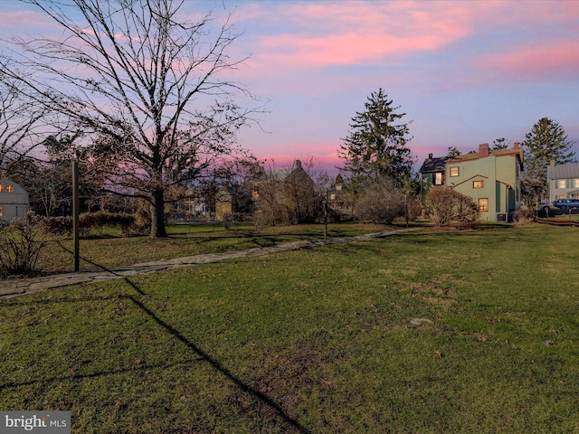 view of yard at dusk