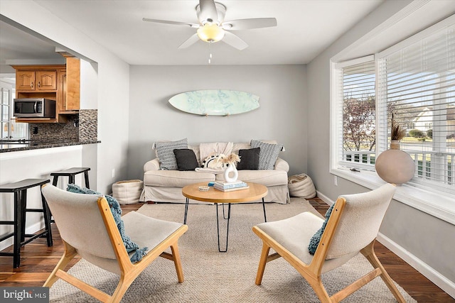 living room featuring ceiling fan and light hardwood / wood-style flooring