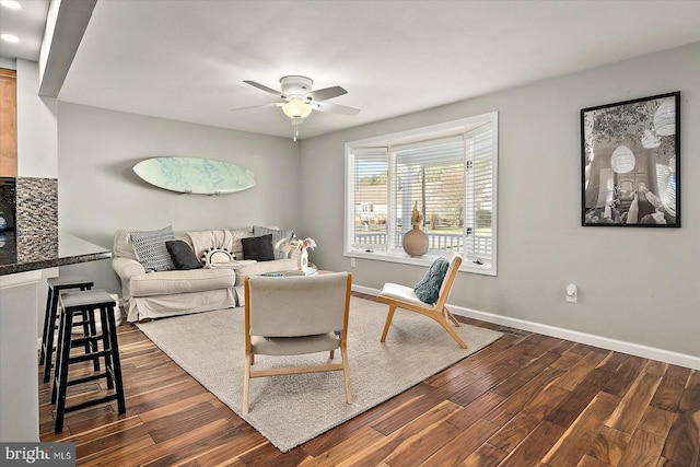 living room with dark hardwood / wood-style flooring and ceiling fan