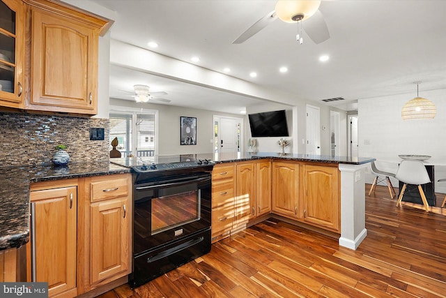 kitchen featuring backsplash, electric range, hardwood / wood-style flooring, dark stone countertops, and kitchen peninsula