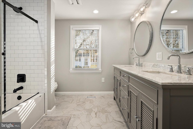 full bathroom with vanity, toilet, and tiled shower / bath