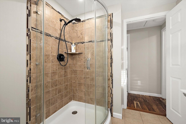 bathroom featuring hardwood / wood-style flooring and a shower with shower door