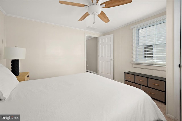 bedroom with carpet, ceiling fan, and ornamental molding