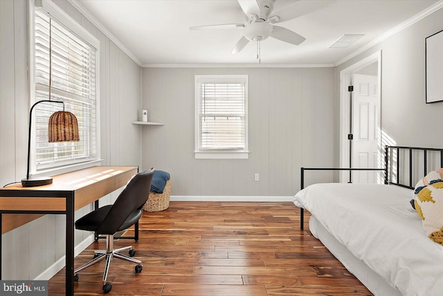 bedroom with hardwood / wood-style floors, ceiling fan, and ornamental molding