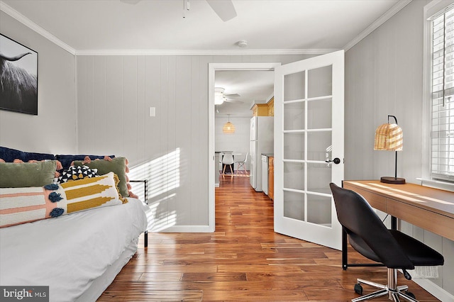 bedroom featuring french doors, ornamental molding, ceiling fan, white refrigerator, and hardwood / wood-style flooring