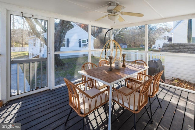 sunroom / solarium featuring ceiling fan