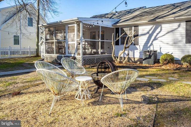 back of property with a sunroom