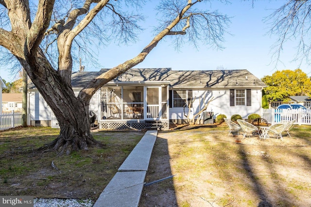 ranch-style home with a sunroom and a front lawn