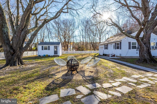 view of yard featuring a shed and a fire pit