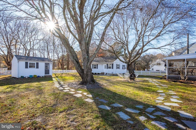 view of yard with an outdoor structure and a sunroom