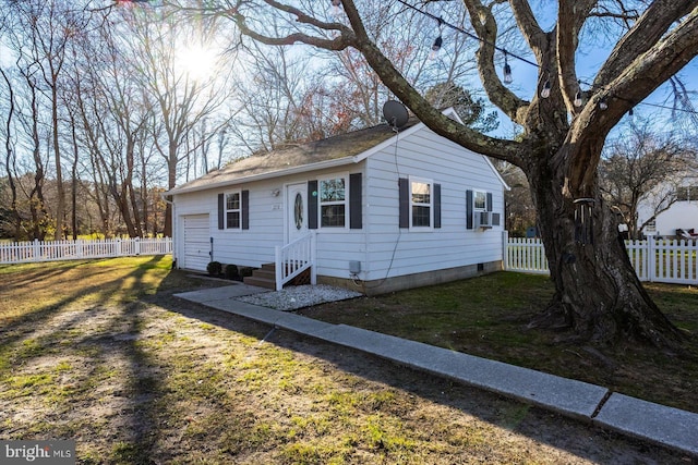 view of side of home featuring cooling unit and a yard