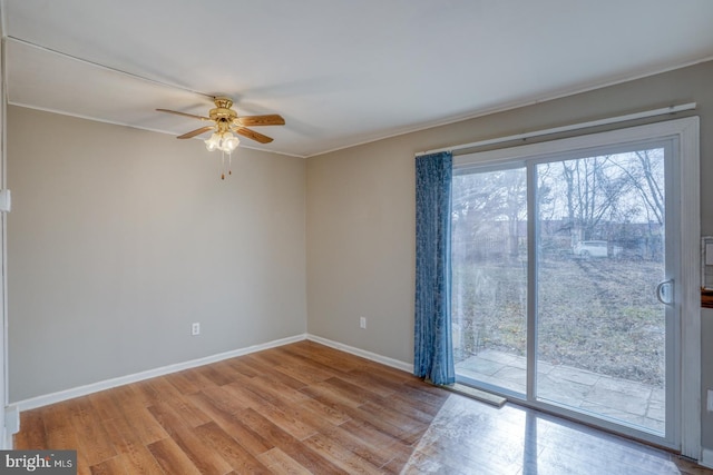 spare room with ceiling fan, light wood-type flooring, and crown molding