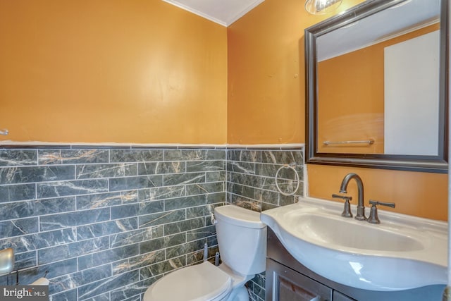 bathroom with vanity, toilet, tile walls, and ornamental molding