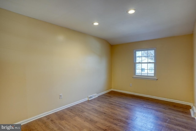 spare room featuring wood-type flooring