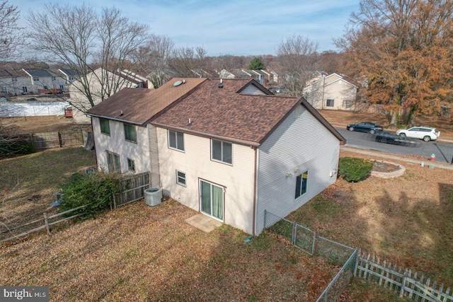 view of side of property featuring central AC and a lawn