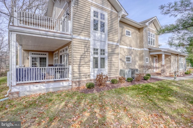 view of home's exterior featuring a balcony and central AC unit