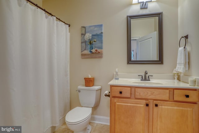 bathroom with tile patterned flooring, vanity, and toilet