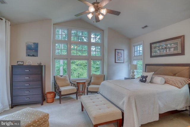 carpeted bedroom with ceiling fan and vaulted ceiling