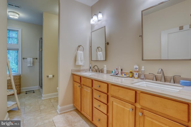 bathroom featuring tile patterned flooring, vanity, toilet, and walk in shower