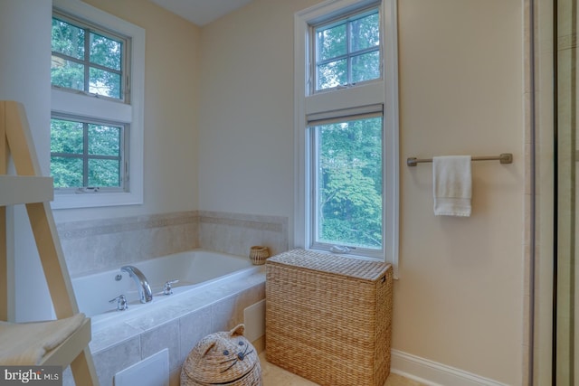 bathroom featuring a relaxing tiled tub