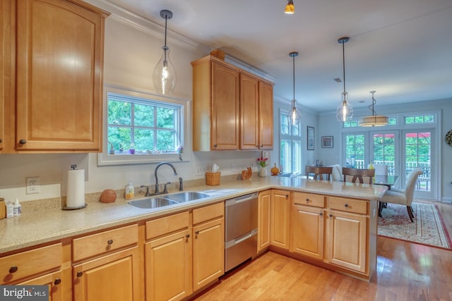 kitchen with kitchen peninsula, plenty of natural light, hanging light fixtures, and light hardwood / wood-style floors