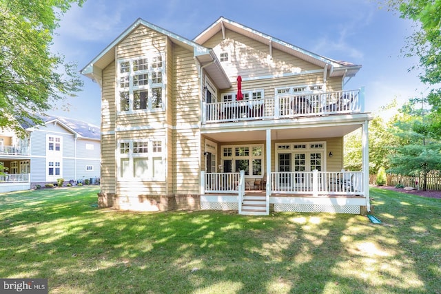 back of house with a porch and a yard