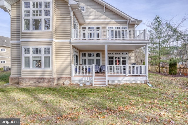 view of front of home with a balcony, a front lawn, and a porch