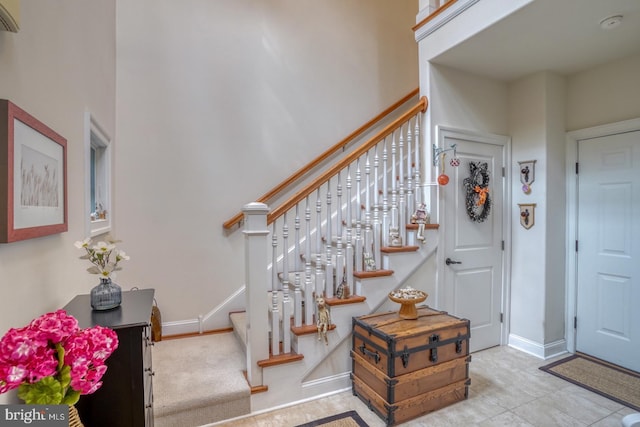 foyer entrance with a towering ceiling