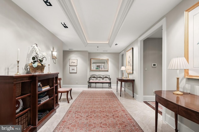 sitting room with a tray ceiling and crown molding