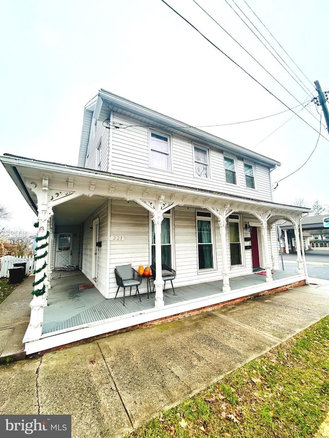 back of property featuring covered porch