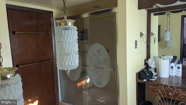 bathroom featuring a shower with shower door