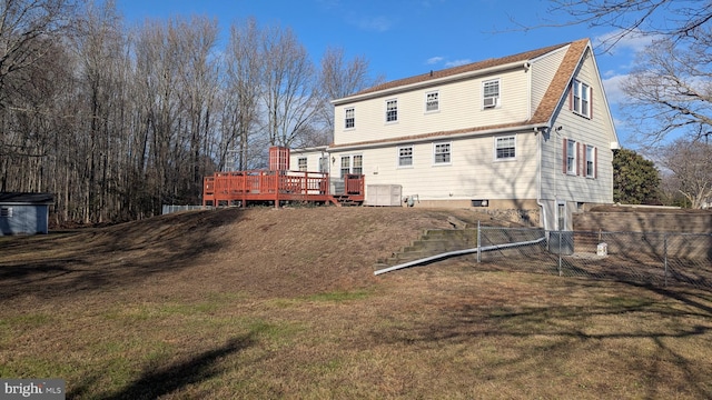 back of property with a lawn and a wooden deck