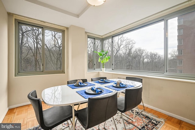 dining space with light parquet flooring