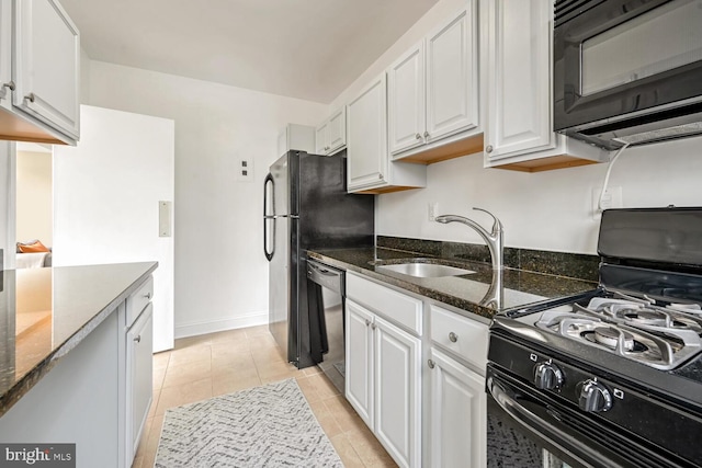 kitchen with white cabinetry, sink, dark stone counters, and black appliances