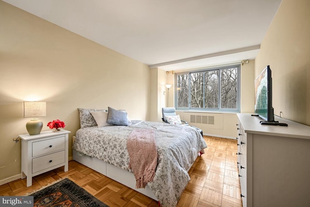 bedroom with light parquet flooring