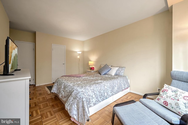 bedroom with light parquet flooring