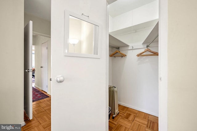 interior space with light parquet flooring and radiator