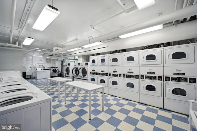 laundry room featuring stacked washer and clothes dryer and washer and clothes dryer