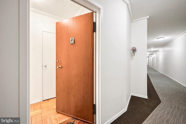 hallway with ornamental molding and parquet flooring