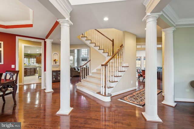 entrance foyer with a wealth of natural light, hardwood / wood-style floors, and ornamental molding