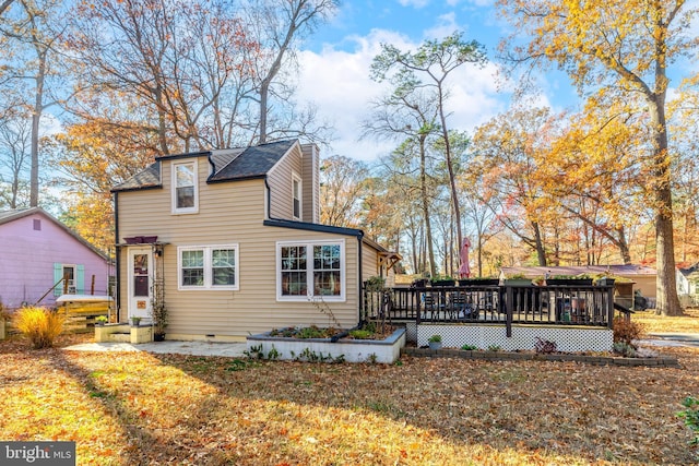 back of house with a yard and a deck