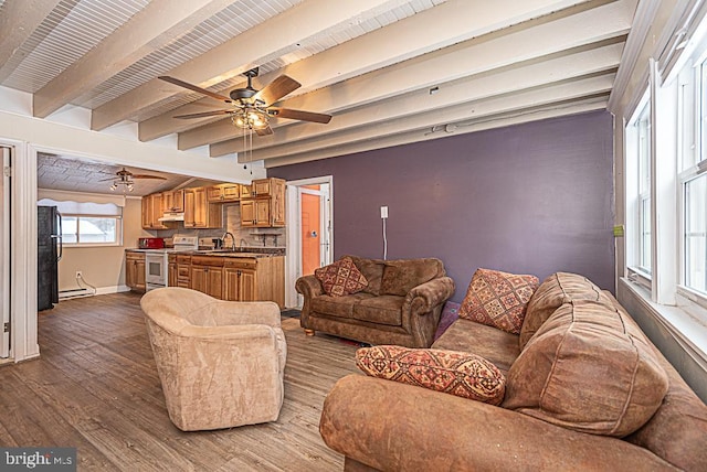 living room featuring beamed ceiling, ceiling fan, sink, and hardwood / wood-style floors