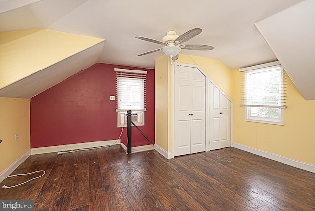 bonus room featuring ceiling fan, dark hardwood / wood-style floors, vaulted ceiling, and a wealth of natural light