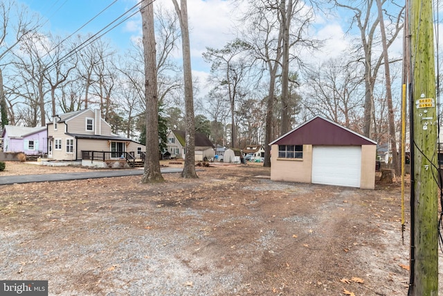 exterior space featuring a garage, an outdoor structure, and covered porch