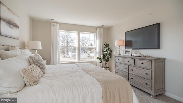 bedroom featuring light colored carpet