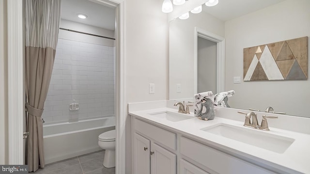 full bathroom with tile patterned flooring, vanity, toilet, and shower / bath combo with shower curtain