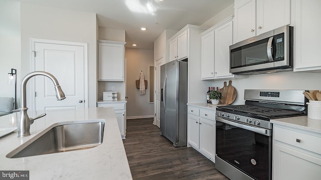 kitchen featuring white cabinets, dark hardwood / wood-style flooring, sink, and stainless steel appliances