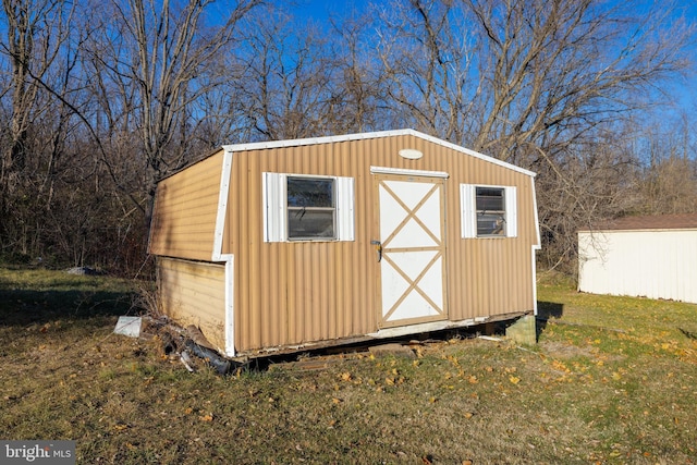 view of outdoor structure featuring a lawn