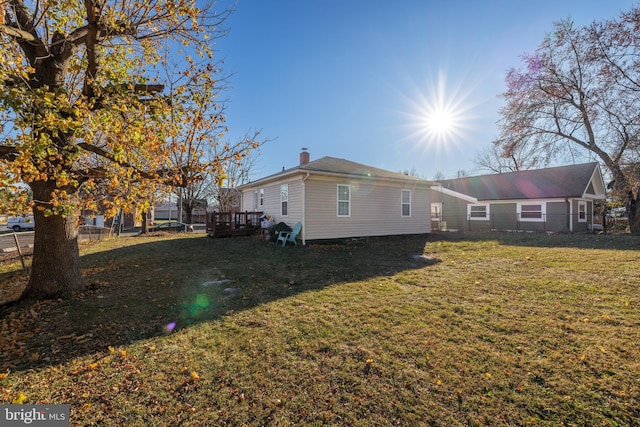 view of property exterior featuring a lawn and a deck